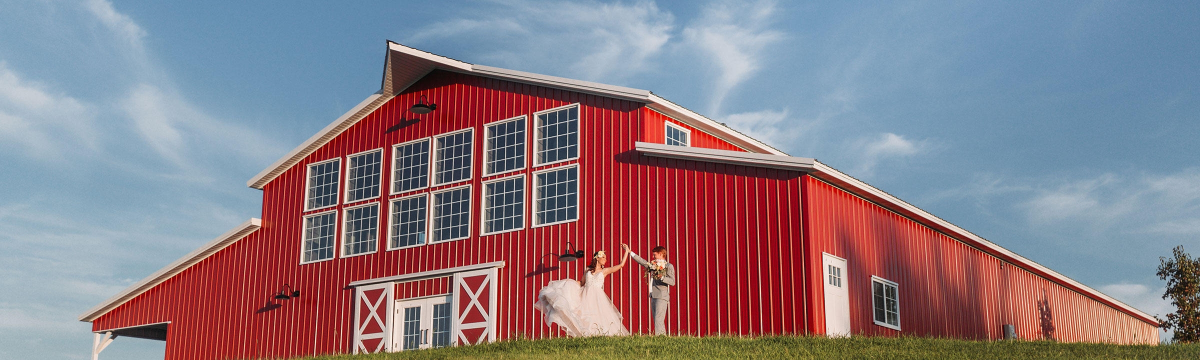 Bride and groom dancing at the back of the barn